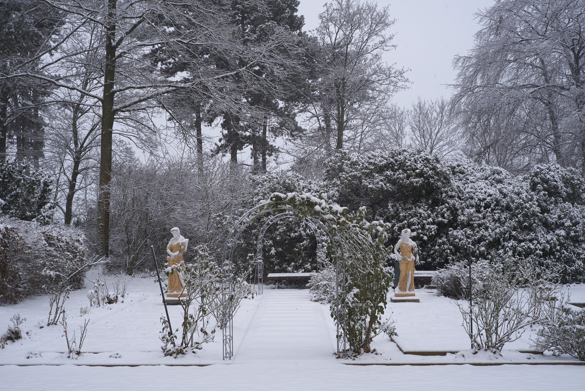 Verschneiter Parkgarten der Villa Bleichert mit Skulpturen und Rosenbogen – ruhige Winteratmosphäre für besondere Feiern im Winter nahe Leipzig